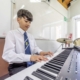 student plays electric piano
