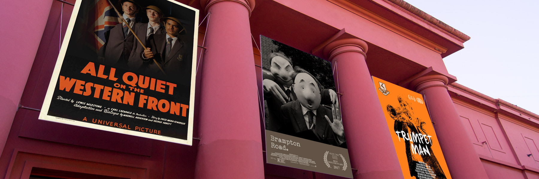 mockup of three theatrical posters for shcool productions hanging outside threatre
