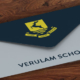 envelope in blue and white with yellow school logo on flap
