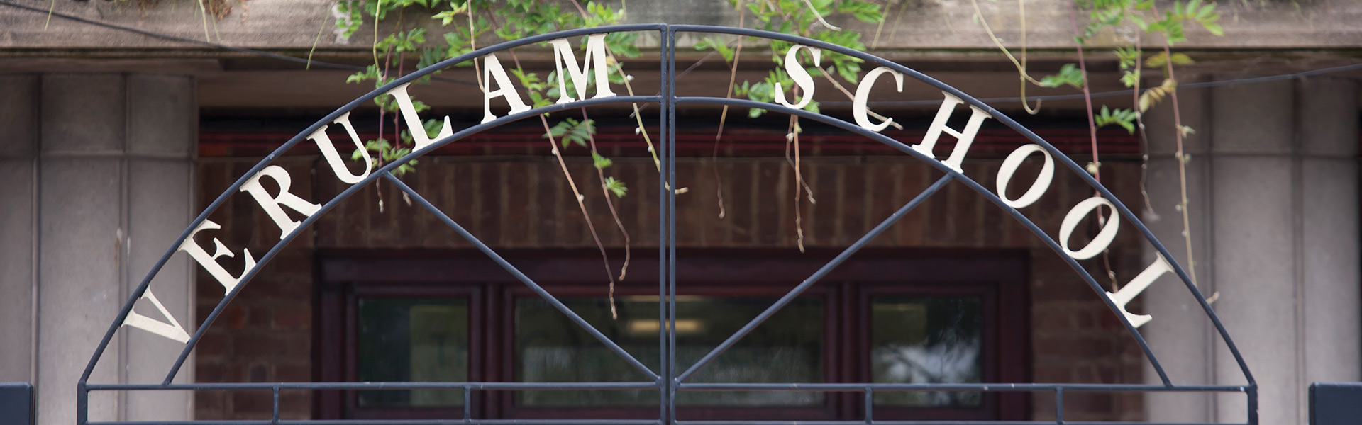 the words 'verulam school' in wrought iron above school gates.