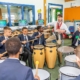 students play bongoes in music lesson