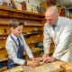 woodworking teacher explains method to student