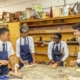 students laughing in woodwork lesson