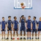 basketball players pose in school gym