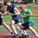 4 students strain as they pull rope in tug or war