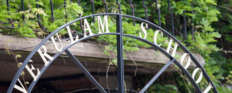 photo of school name in wrought iron at gates