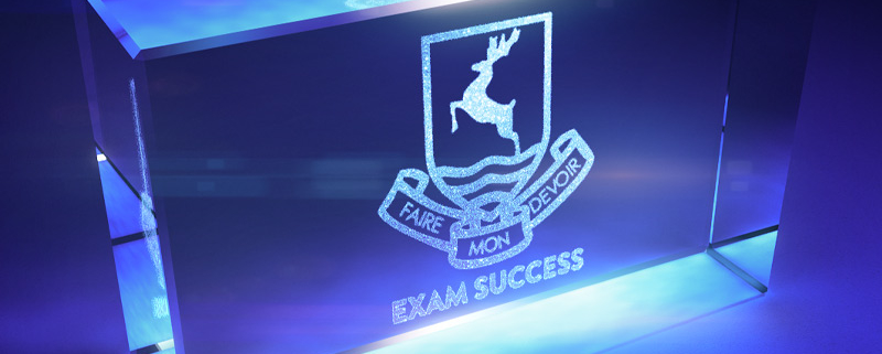 school logo with the words 'exam success' laser-etched into glasss block