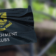 dark blue flag waving in the wind with verulam school logo and the words 'enrichment clubs'